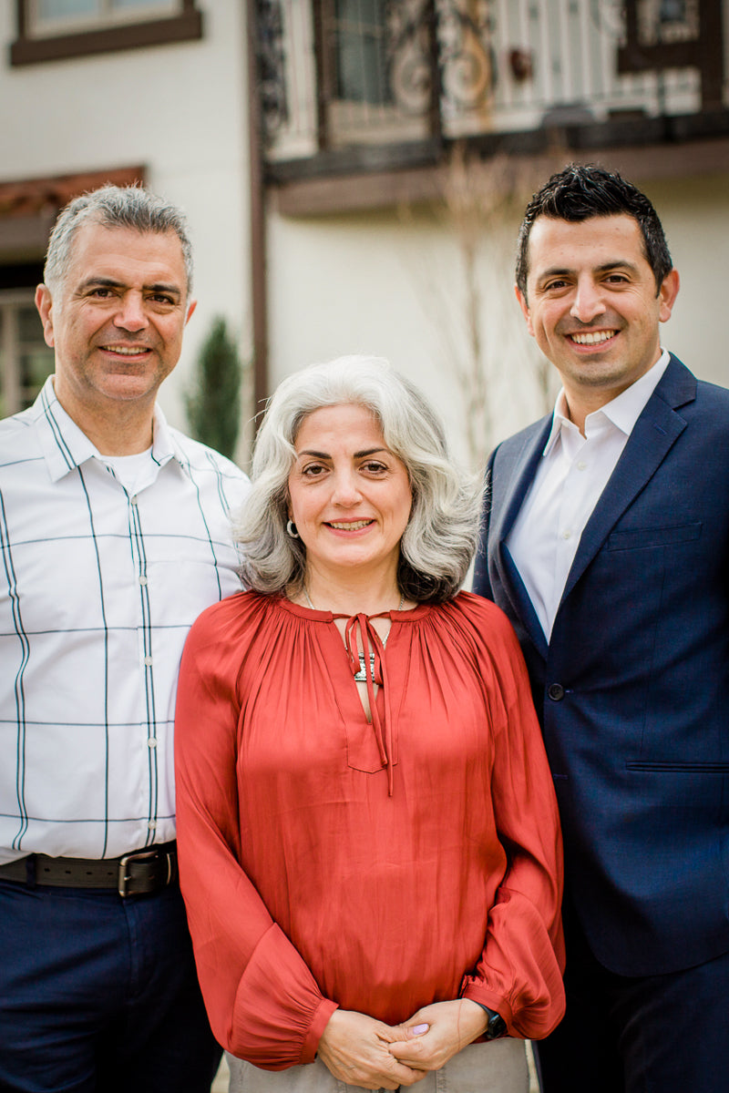 A photo of the three owners of Cascade Manufacturing. On the right is a gentleman in his late 50s. In the middle is his wife, a woman in her early 50s. And on her right, is her brother, a man in his early 40s. They are Iranian.
